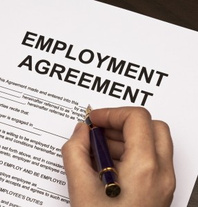 female hands filling out employment agreement contract